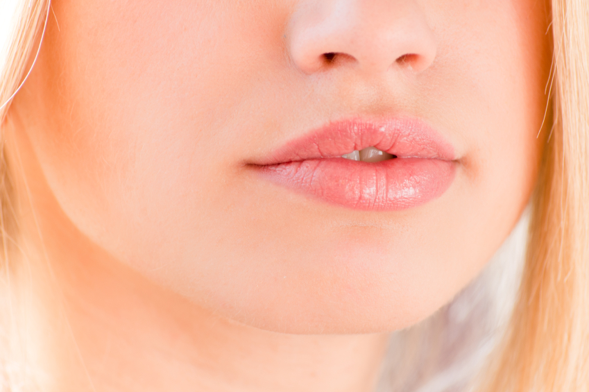 plump lips beautiful blonde on a white background closeup