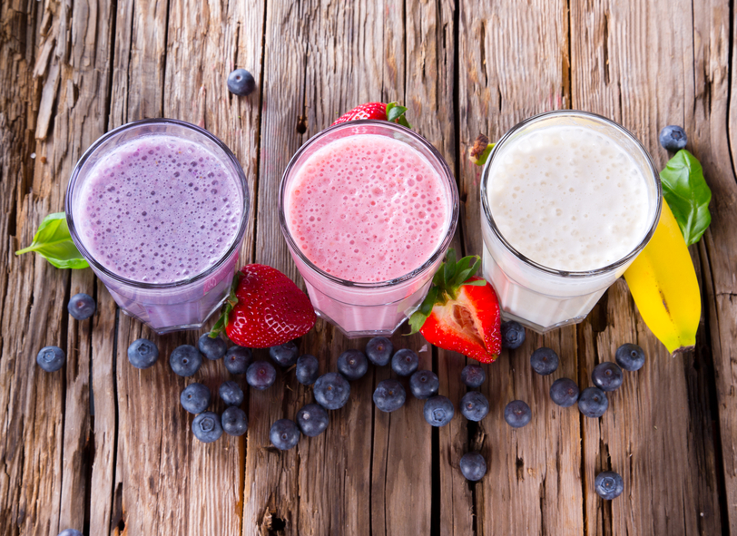 Fresh fruits milk shake on wood