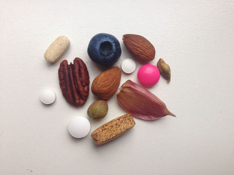 pills vitamins and fruits, nuts